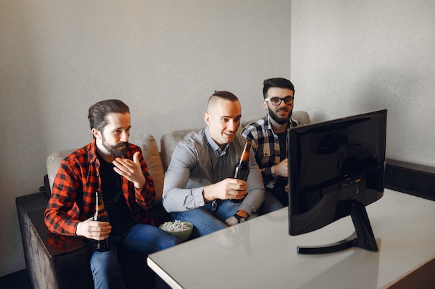 Group of fans are watching soccer on the TV