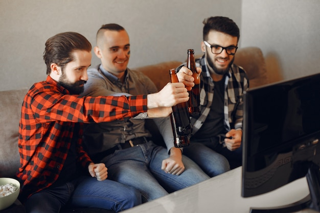 Free photo group of fans are watching soccer on the tv