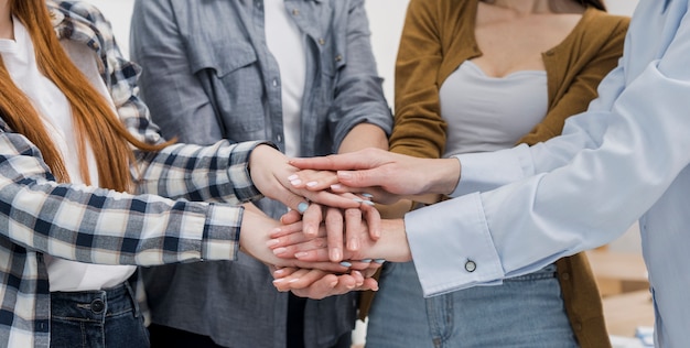 Group of female friends touching hands