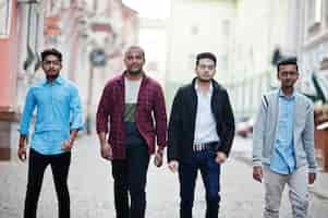 Free photo group of four indian teen male students classmates spend time together