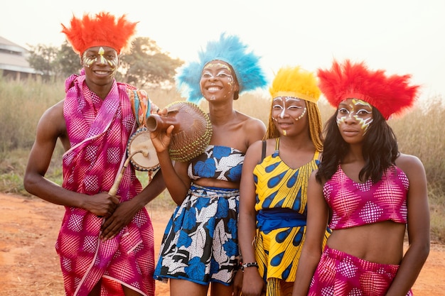 Group of friends at african carnival with costumes