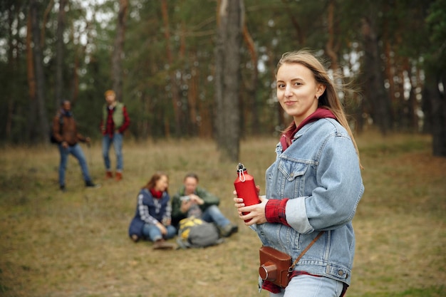 Free Photo group of friends on a camping or hiking trip in autumn day