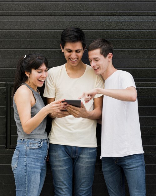 Group of friends checking a tablet