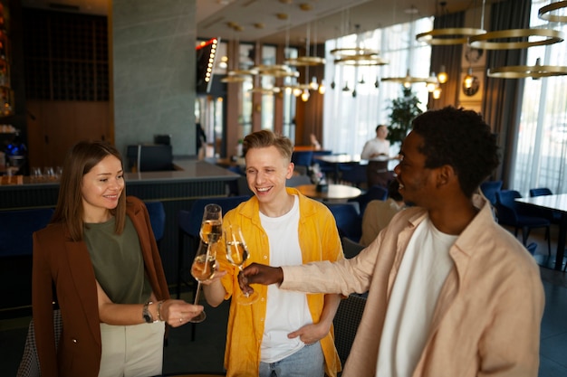 Group of friends cheering with wine glasses at a restaurant