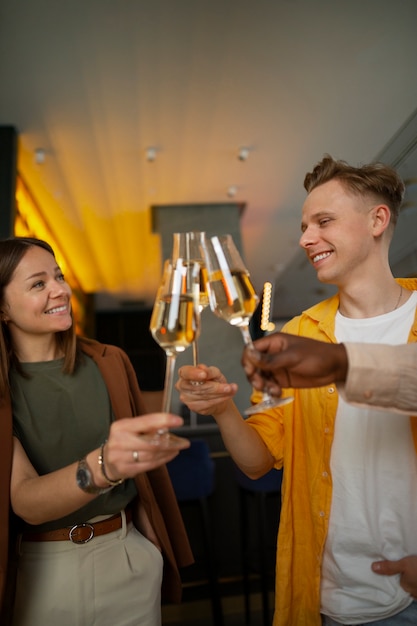 Group of friends cheering with wine glasses at a restaurant