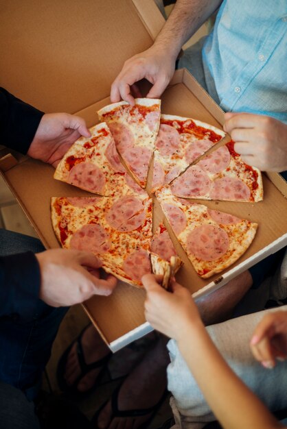 Group of friends eating pizza