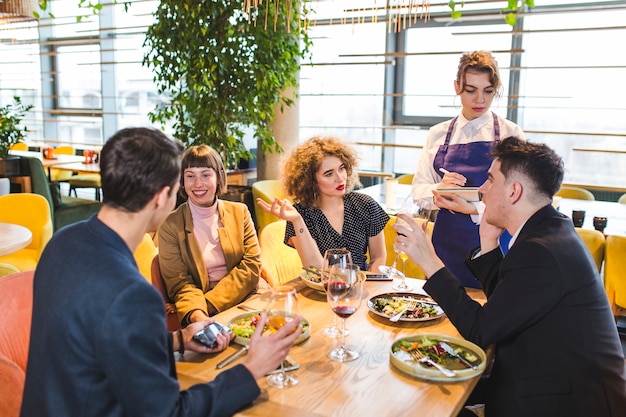 Group of friends eating in restaurant