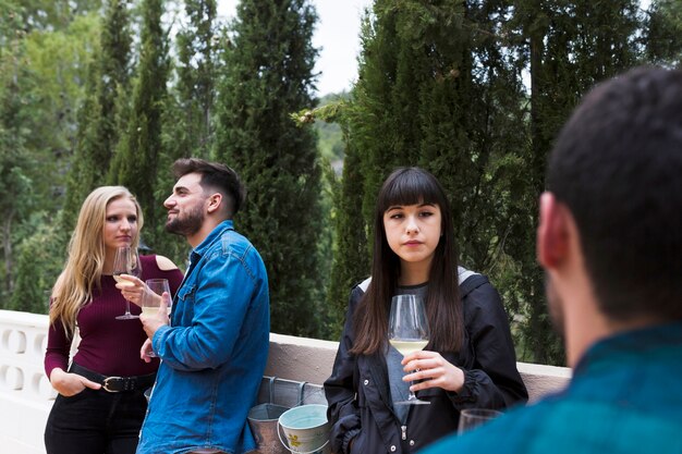 Free photo group of friends enjoying drinks outdoors