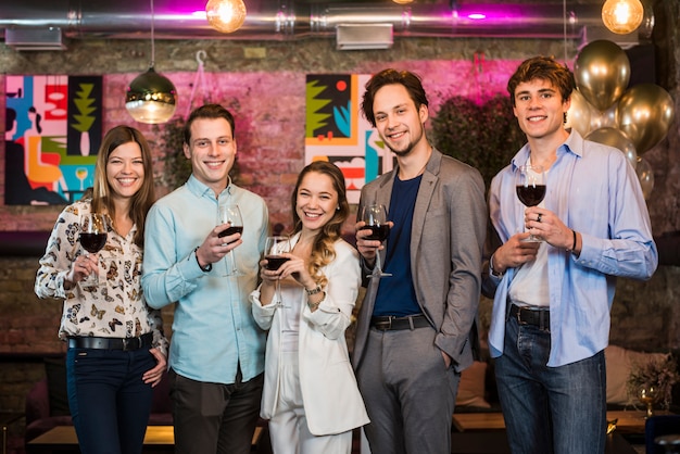 Group of friends enjoying evening drinks in bar