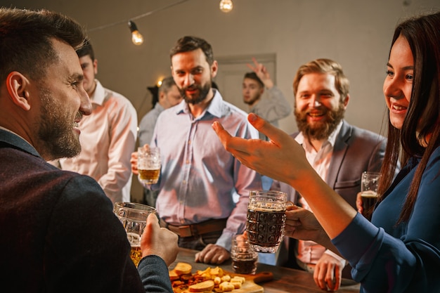 Group of friends enjoying evening drinks with beer