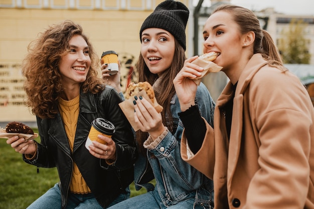 Free photo group of friends enjoying sweets together