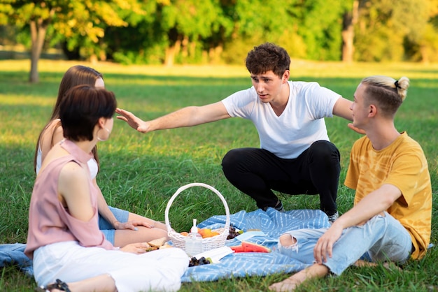 Group of friends having fun at a picnic