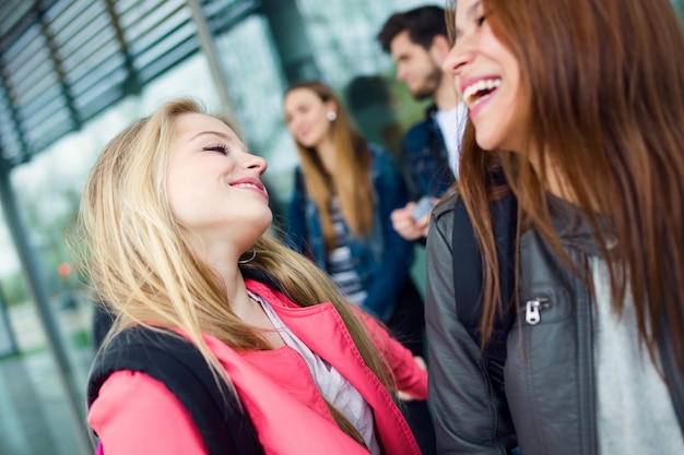 Group of friends having fun in the street after class.