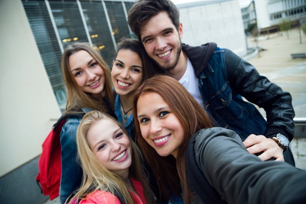 Group of friends having fun in the street after class.