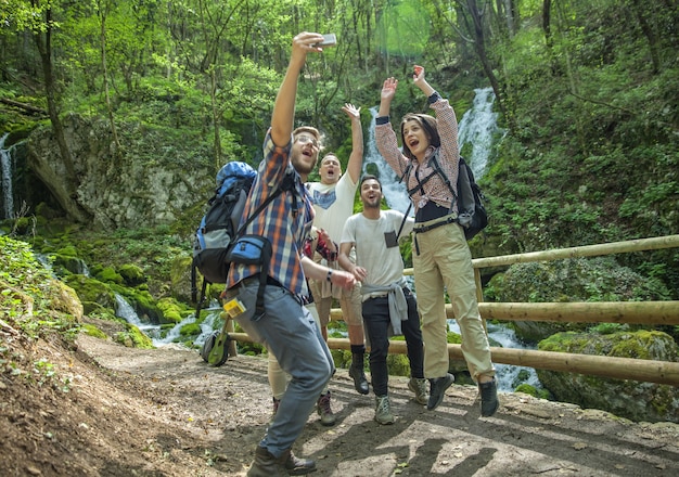 Free photo group of friends having fun and taking selfies in nature