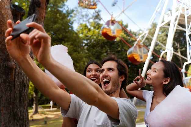 Group of friends having fun together at a ferris wheel