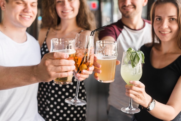 Free photo group of friends holding different type of alcohol drinks