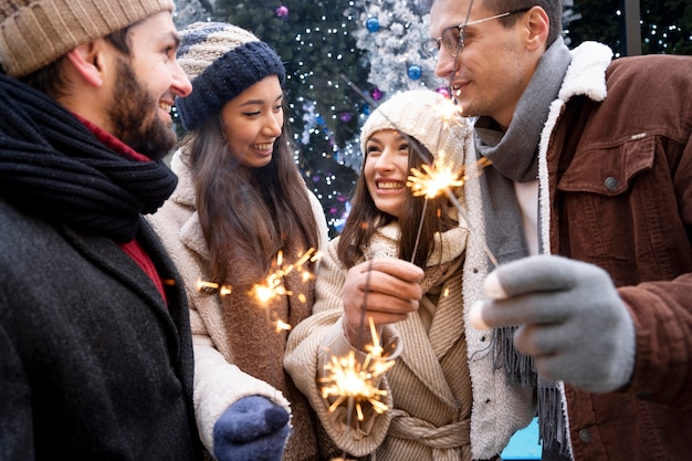 Free photo group of friends holding sparklers together