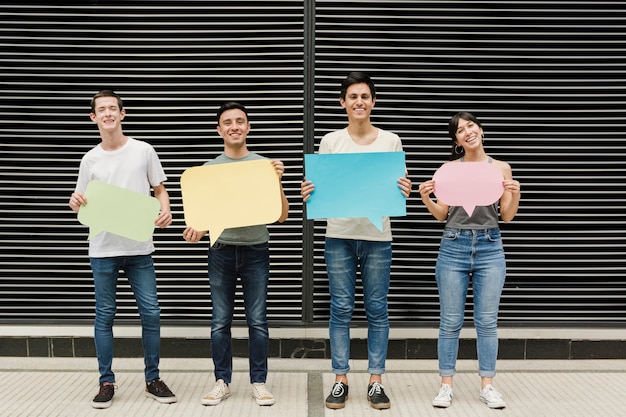 Free photo group of friends holding speech bubbles