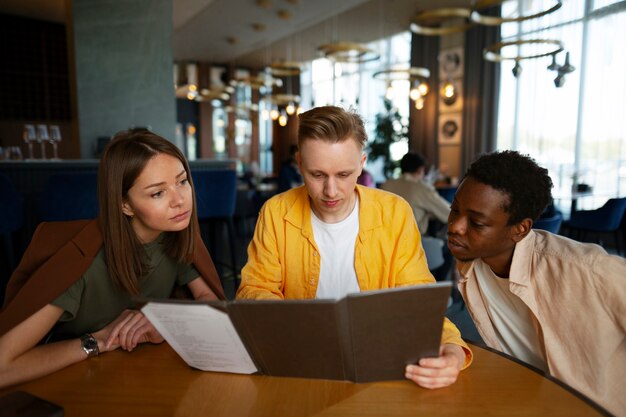 Group of friends looking at the menu together at restaurant