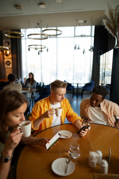 Free Photo group of friends looking at the menu together at restaurant