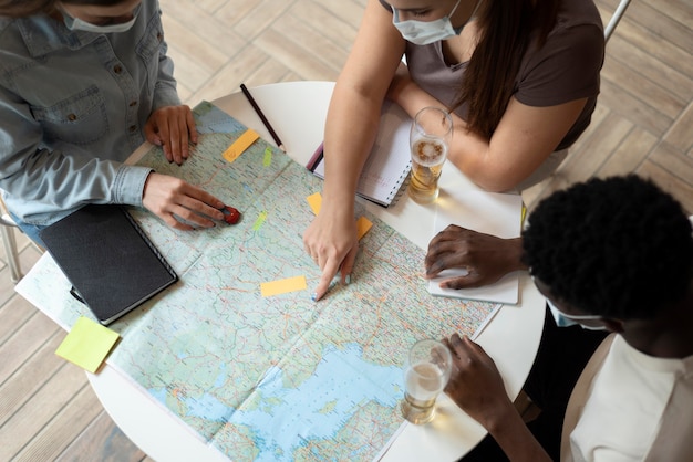 Group of friends planning a trip in a cafe