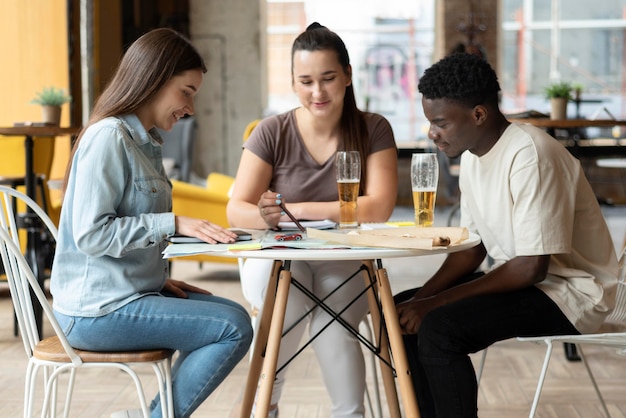 Group of friends planning a trip in a cafe