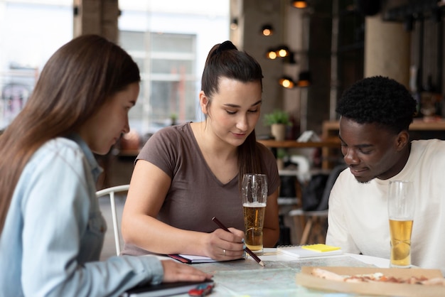 Group of friends planning a trip in a cafe