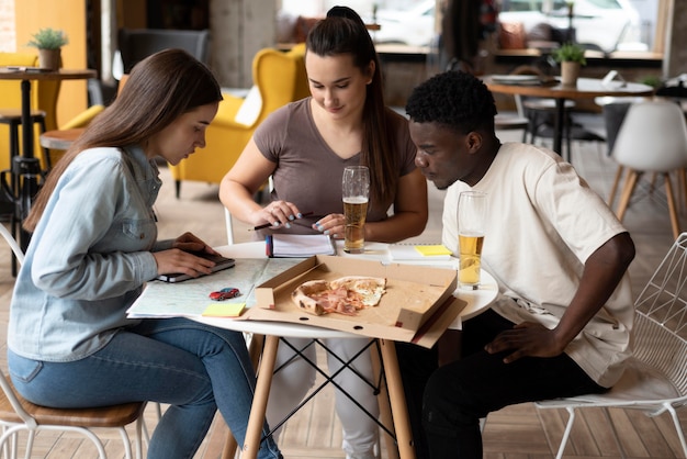 Group of friends planning a trip in a cafe