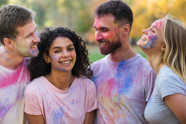 Free photo group of friends posing covered in color