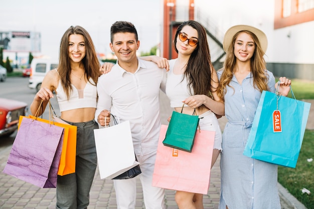 Group of friends posing with paper bags