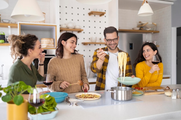 Group of friends preparing meal in the kitchen