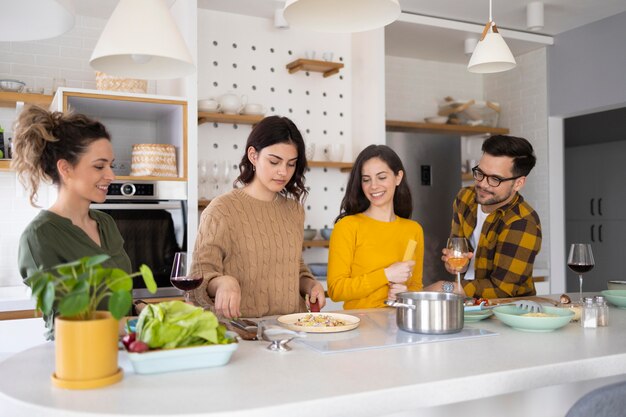 Group of friends preparing meal in the kitchen