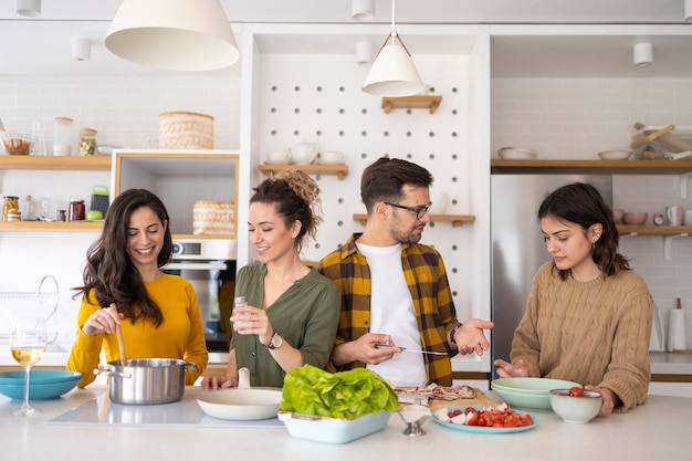 Group of friends preparing meal in the kitchen