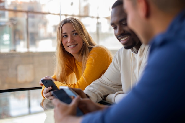 Group of friends reading cell phone messages