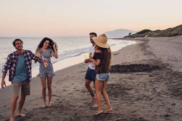 Group of friends at the shoreline at sunset