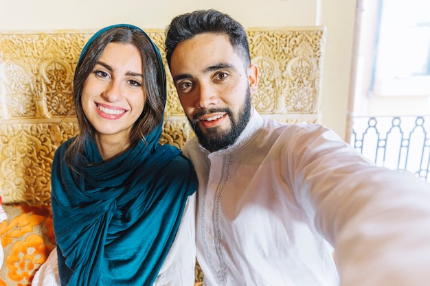 Free photo group of friends taking selfie in arab restaurant