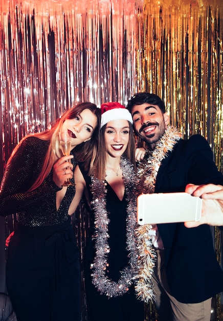 Free Photo group of friends taking selfie on new years party