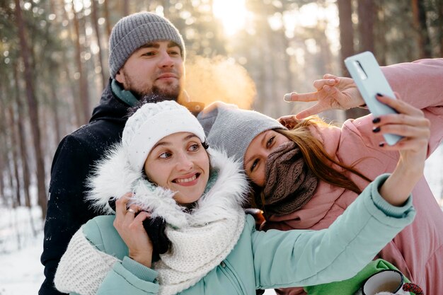 Group of friends taking selfie outdoors in winter