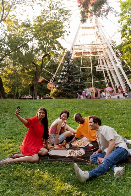 Group of friends taking a selfie while out at the ferris wheel