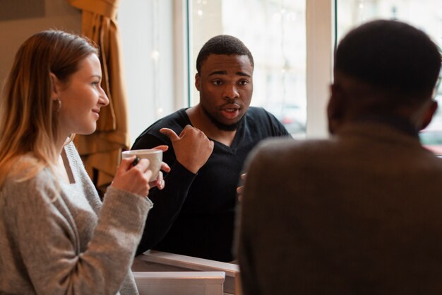 Group of friends talking and drinking coffee