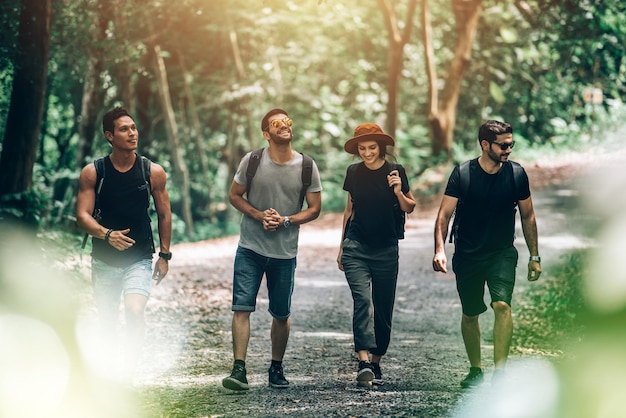 Group of Friends Walking Together into the Forest for Adventure and Explororing Travel in Summer Holiday Concept