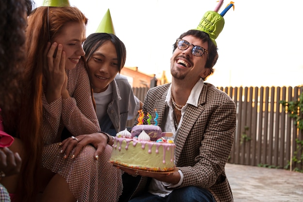 Group of friends with cake at a surprise birthday party