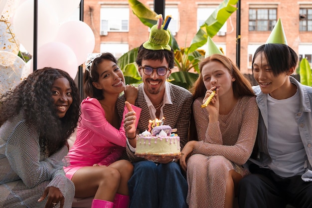 Group of friends with cake at a surprise birthday party