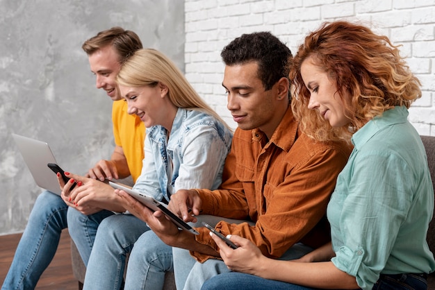 Group of friends with electronic devices