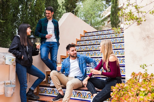 Group of friends with wine glasses on staircase