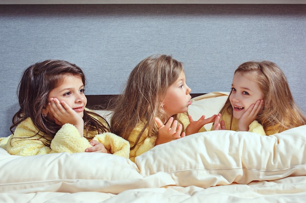 Free photo the group of girlfriends taking good time on bed