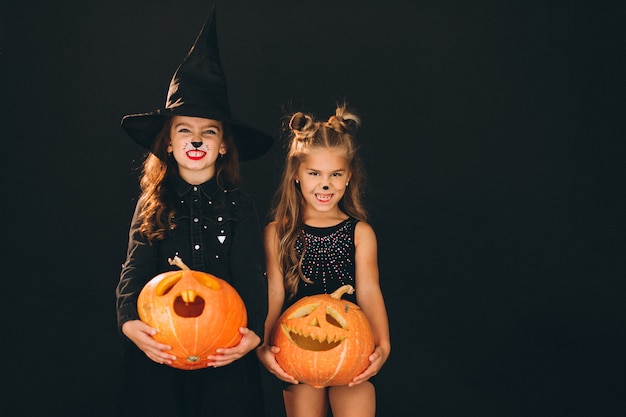 Group of girls dressed in halloween costumes in studio