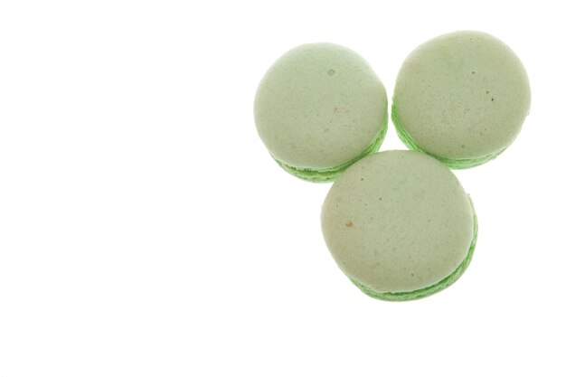 Group of green macaroons isolated on white background. Delicious hazelnut