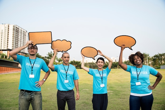 Free photo group of happy and diverse volunteers with speech bubbles